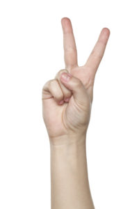 Human hand showing the victory symbol